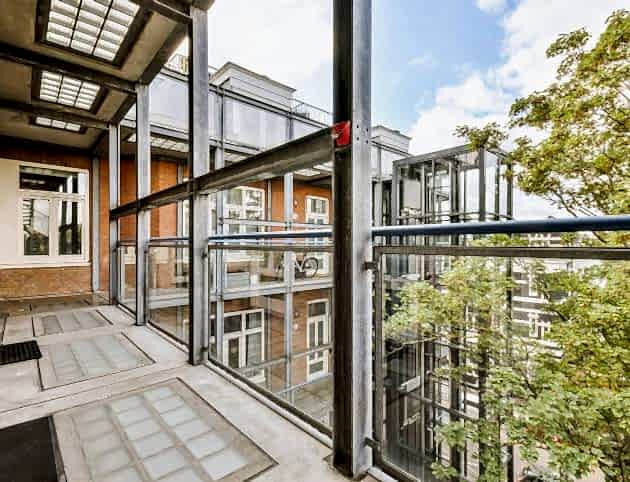 Attractive long narrow balcony with glass railings