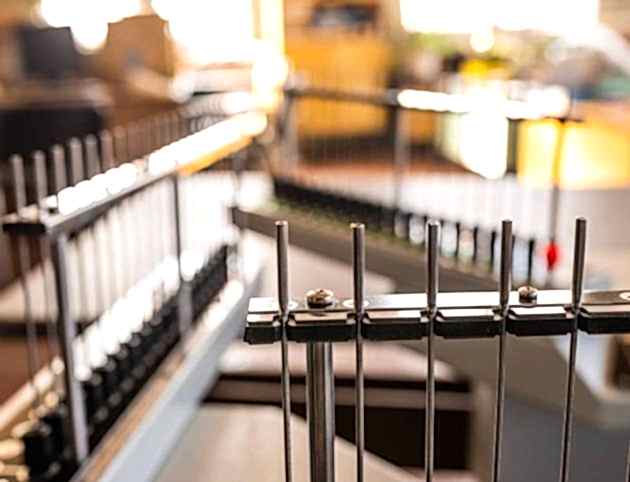 Close-up side view of metal antennas and numbered buttons on the metal panel of radio-controlled equipment in production. Secret military base concept